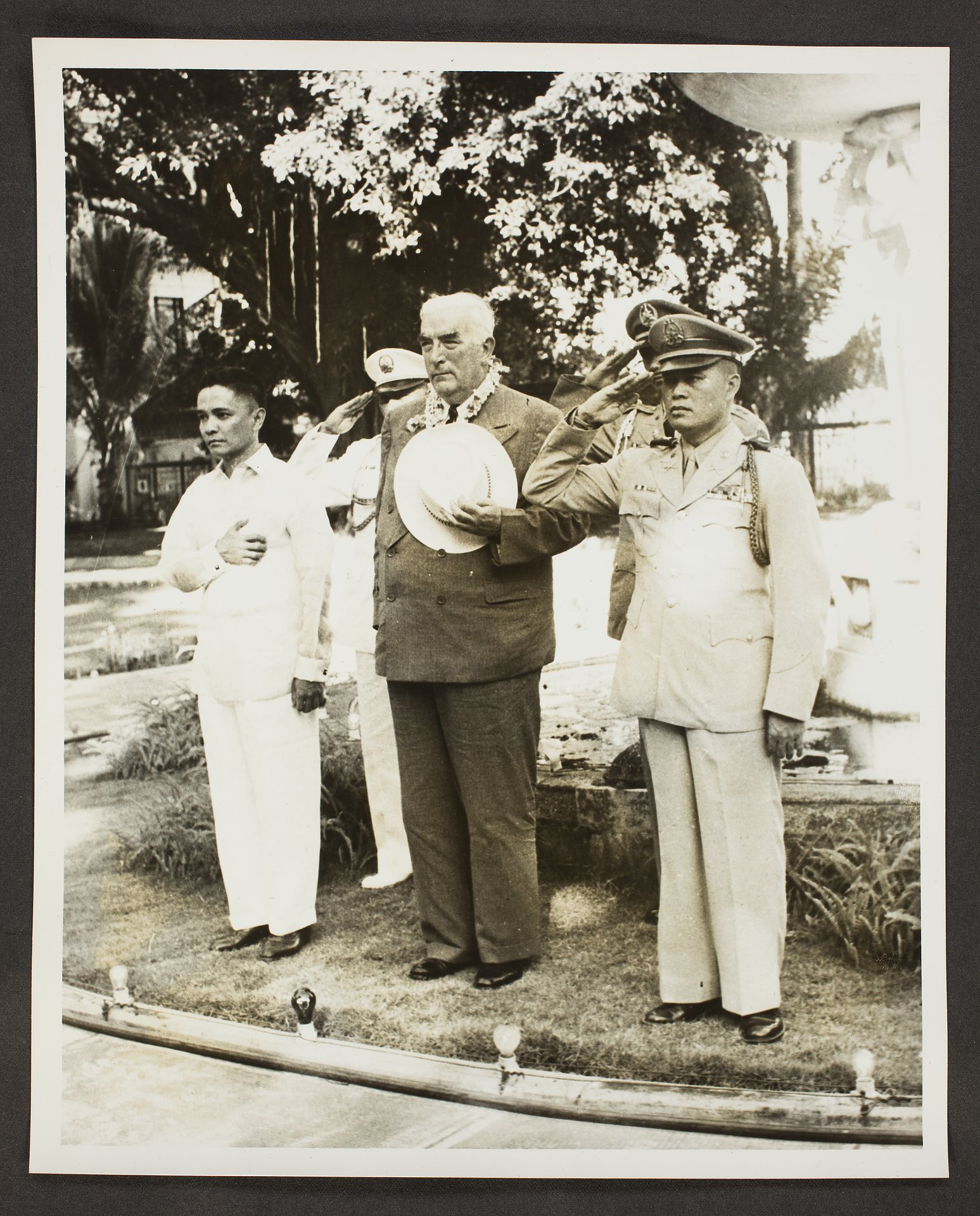 Robert Menzies standing to attention on arrival in the Philippines in 1957